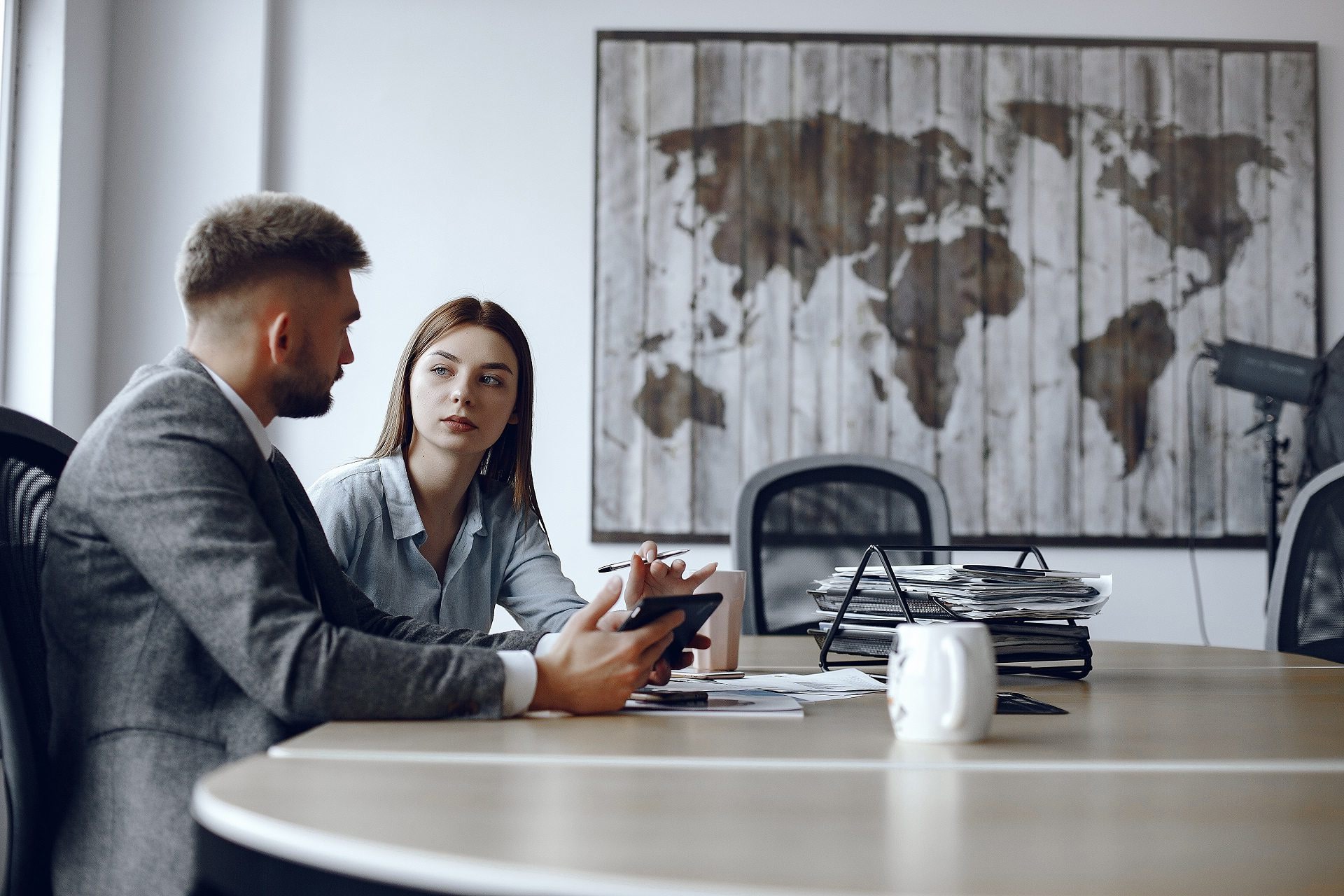 man-uses-tablet-business-partners-business-meeting-people-are-sitting-table-min